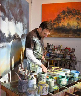 Eric O'Dell painting in his studio